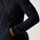 Detailed close-up of Regatta arm badge and pocket placement on the navy black hoodie, showing textured fabric and fleece lining.