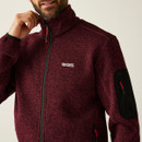 Close-up view of the NEWHILL dark maroon fleece jacket highlighting the textured fabric, Regatta Great Outdoors logo on the chest, and black zip pocket on the sleeve.