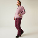 Woman in full outdoor outfit wearing lilac pink DARE2B fleece and burgundy trousers, standing in a relaxed pose.