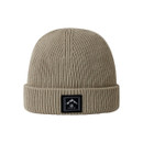 The front of a stone coloured beanie hat with a black brand logo on the front of the roll cuff.