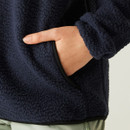 Close-up of the side pocket in use, highlighting the soft texture of the fleece and black binding along the pocket opening.