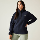 Front view of a woman wearing the navy Dare2b Slide Out Fleece with a half-zip and high collar, posing with one hand on her hip.