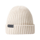 The front of a light grey hat with a small black brand logo on the front of the roll cuff.