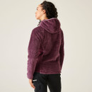 The back of a woman wearing a purple fluffy fleece with a hood.