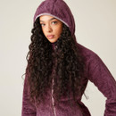 A woman wearing a purple full zip fleece with the hood up.