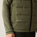 Close-up of lower torso showing the gilet’s "Feather Free" detail and texture of olive ripstop fabric.