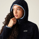 A woman wearing a navy full zip fleece with the hood up.