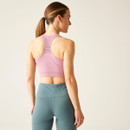 Rear view of the model in lilas sports bra showing full racerback cut and seamless, breathable fabric.