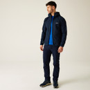 Full-body lifestyle image of man wearing the Navy AREC III jacket with coordinating outdoor gear, demonstrating the jacket’s practicality and style.