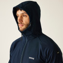 Close-up portrait of a man wearing the hood up on the Navy AREC III softshell, showing wind-resistant protection and drawcord detail.