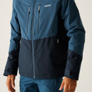 A close-up of a person wearing a blue and black outdoor jacket with multiple zippered pockets. The jacket has a sporty, functional design.