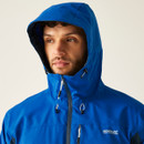 Man wearing a blue hooded jacket with a zip, looking pensive. The jacket features the logo "Regatta Great Outdoors." Background is plain.