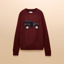 Burgundy crew neck knitted jumper laid flat against a neutral background, featuring an embroidered 4x4 vehicle motif in earthy tones on the front.