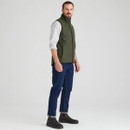 Side view of the Ridgeline Monarch gilet in deep forest green worn by a man dressed in blue jeans and dark boots.