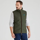 Front view of a man wearing the Ridgeline Monarch gilet in deep forest green, styled over a long-sleeve checked shirt.