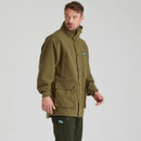 Teak green Ridgeline Torrent jacket modelled at an angle to display the adjustable hood, storm flap closure and spacious cargo pockets.