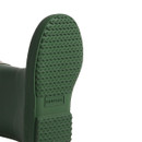 The sole of a dark green hunter wellington boot.