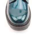 A close up view of a glittery blue Heavenly Feet ankle boot on a white background A close up view of a glittery blue Heavenly Feet ankle boot on a white background