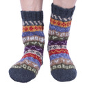 Knit socks feature vibrant stripes in blue, red, and green hues. The pattern is cosy and colourful, suggesting warmth and comfort.