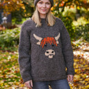 Woman in a grey sweater with a cow design stands in an autumn garden, surrounded by colourful leaves and greenery, smiling gently. Cosy and serene mood.