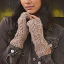 Centred close-up of the model’s hands held near her chin, highlighting the thick cable-knit pattern and soft mushroom colour of the handwarmers, paired with a black denim jacket.