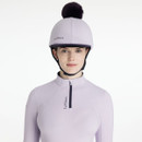 Lilac riding helmet silk with dark faux fur pom-pom, paired with a matching base layer featuring a navy quarter zip and LeMieux branding.