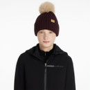 Damson ribbed knit beanie with beige faux fur pom-pom and LeMieux logo patch, styled with a black LeMieux jacket.
