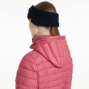 Back view of a woman wearing a LeMieux Clara ribbed knit knot headband in navy, paired with a pink padded jacket.
