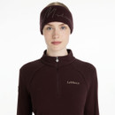 Front view of woman wearing a LeMieux sparkle headband in damson, paired with a matching quarter zip top.