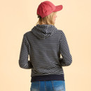 A person facing away, wearing a red cap and a navy, striped hoodie. The background is beige. The mood is casual and relaxed.