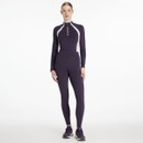 Full-length view of model wearing LeMieux Naomi pull-on breeches in juniper purple, styled with matching performance top and trainers.