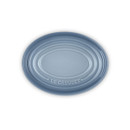 Overhead view of a light blue Le Creuset stoneware spoon rest with concentric ring design and embossed logo.