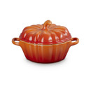 Side view of the Le Creuset Stoneware Mini Pumpkin Casserole Dish with lid on, in Volcanic orange, showing both side handles.