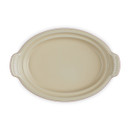 Interior view of the Le Creuset Pumpkin Butter Dish base without the lid, revealing its smooth cream-coloured glazed surface and wide oval shape.