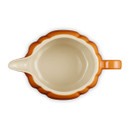 Top-down view of the Le Creuset Pumpkin Gravy Jug in Volcanic, showing the cream interior, pouring spout, and handle.