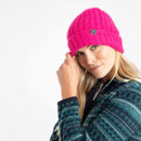 A side view of a woman wearing a bright pink beanie hat.