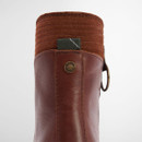 Close-up of Barbour Dahlia chestnut leather ankle boot showing rear pull tab with tartan detail and branded rivet