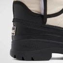 Back heel view of Barbour Braybourn beige and black ankle boots with logo patch.