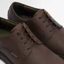 Lace-up front view of men’s brown leather derby shoes with Barbour branding.
