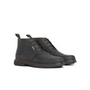 Black leather chukka boots with lace-up front, rounded toe and low stacked sole, shown at a three-quarter angle on a white background.