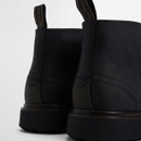 Close-up of the heel and rear stitching on black leather chukka boots, highlighting pull tabs and sole detail.