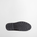 Outsole view of olive suede Chelsea boot with textured tread pattern for grip.