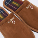 Close-up of Barbour men’s brown suede mule slippers with tartan lining and embroidered Barbour logo on the upper