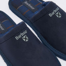 Close-up of Barbour navy mule slippers with embroidered logo and tartan lining detail