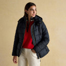 Woman styling Hadlow navy quilted jacket open with red half-zip jumper