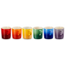 A set of six mugs in red, orange, yellow, green, blue, purple positioned in a row.