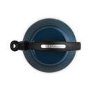 A view of the top of the dark blue kettle with a black handle.
