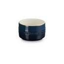 The front of a dark blue stackable ramekin.