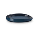 A side view of a dark blue coloured oval spoon rest.