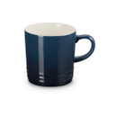 Navy blue stoneware mug with cream interior, angled side view.